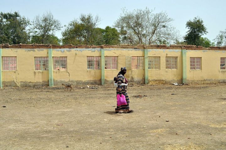 The new video was shown to three mothers of the missing schoolgirls, who recognized their daughters and some others in the video. A mother of an abducted girl walks past the school where the kidnapping took place.