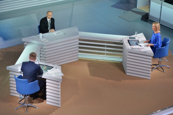 Rossiya TV Channel journalist Yevgeny Rozhkov, Russia's President Vladimir Putin and Channel One news anchor Valeria Korablev