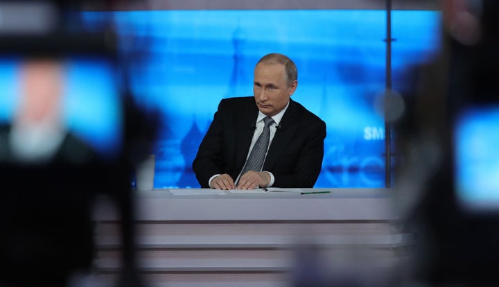 Russian President Vladimir Putin listens to a question during his annual televised call-in show in central Moscow on April 14