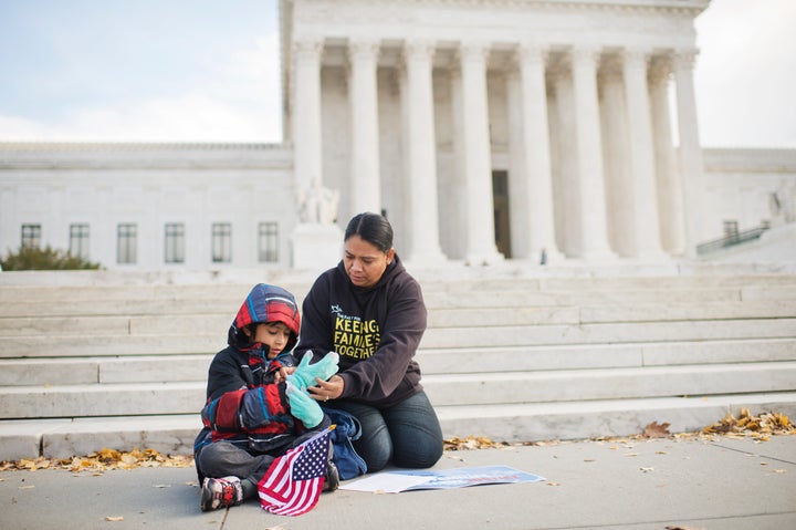 Another immigrant, Rosario Reyes, originally from El Salvador, and her 7-year-old son Victor attend a December press conference in support of DAPA.