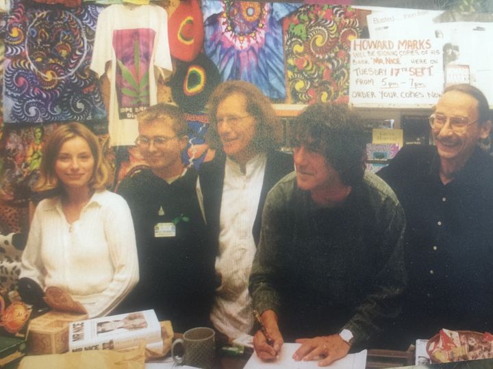 Howard Marks signs copies of his book, next to Harris, middle