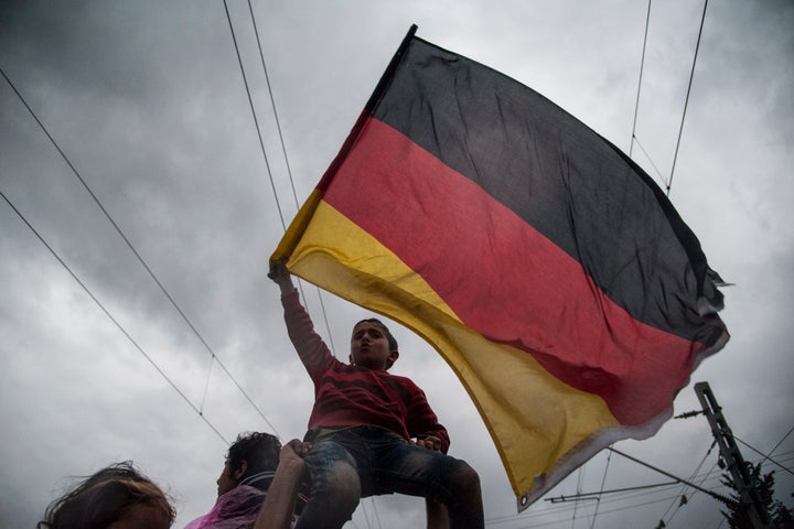 The founders of many civic action groups that help refugees settle and integrate into society have encountered opposition among certain demographics in Europe. Refugees wave a German flag at the Greece-Macedonia border.