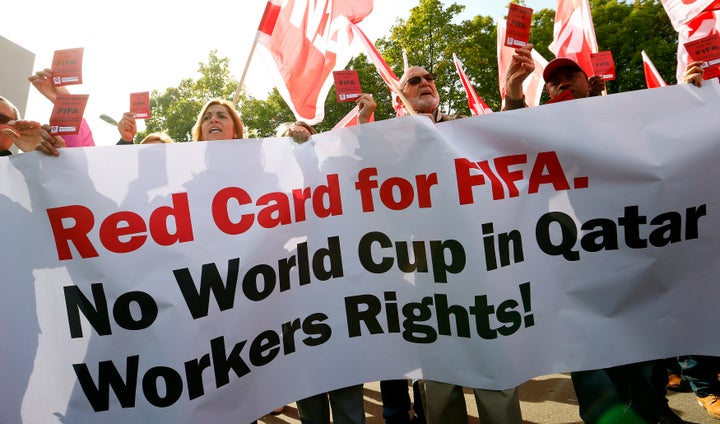 Protesters challenge FIFA to respect the rights of migrant workers in Qatar outside the organization's headquarters in Zurich, Switzerland.