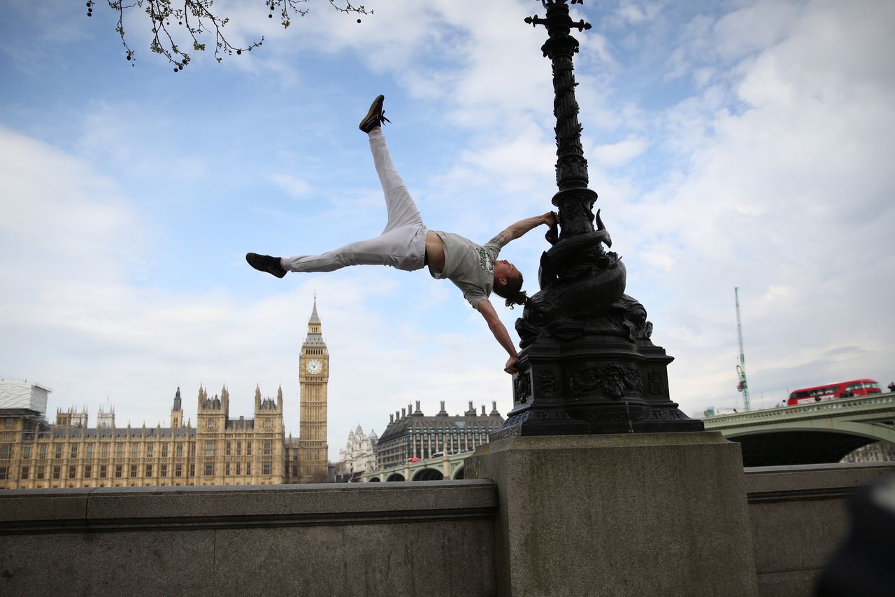<strong>British Parkour expert Tim Shieff performs a hand-stand in front of the House of Commons, as he launches Jungle Book inspired Parkour masterclasses on Londons Southbank, to celebrate the release of The Jungle Book.</strong>