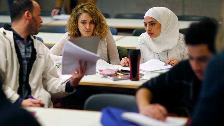 Migrants who worked as teachers in their home countries takes part in a programme to educate them for German schools at the University in Potsdam, Germany, April 14, 2016. REUTERS/Hannibal Hanschke