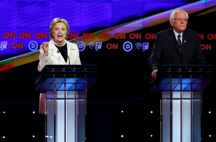 Democratic presidential hopeful Hillary Clinton speaks as Sen. Bernie Sanders (I-Vt.) listens during a Democratic d