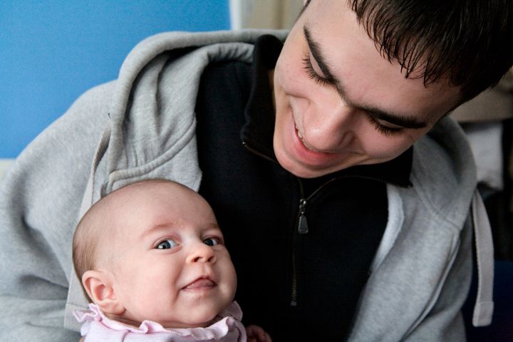 <strong>File photo of a young teenage father with his one-month old daughter</strong>
