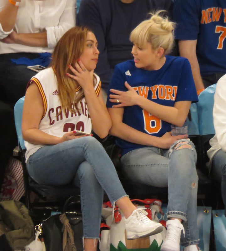 <strong>Miley's diamond ring was clearly on show when she enjoyed a basketball match with her sister just weeks ago </strong>