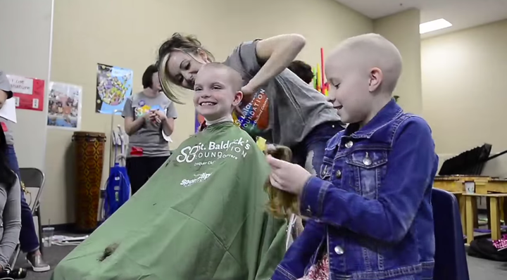 Student gets her head shaved at Meridian Elementary School.