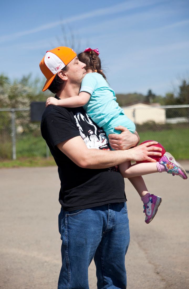 Bryan Thouvenel holds his daughter Harmony, 5, after playing ball in front of their home in Myrtle Creek, Saturday, April 3, 2016. Thouvenel was recently reunited with Harmony after being separated for three years.