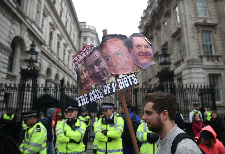 Demonstrators hold placards during last week's protest outside Downing Street