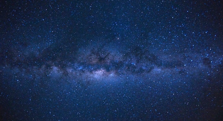 Our Milky Way galaxy, as seen from the French island of Reunion in the Indian Ocean. There are about four dozen galaxies that we know of which circle it.