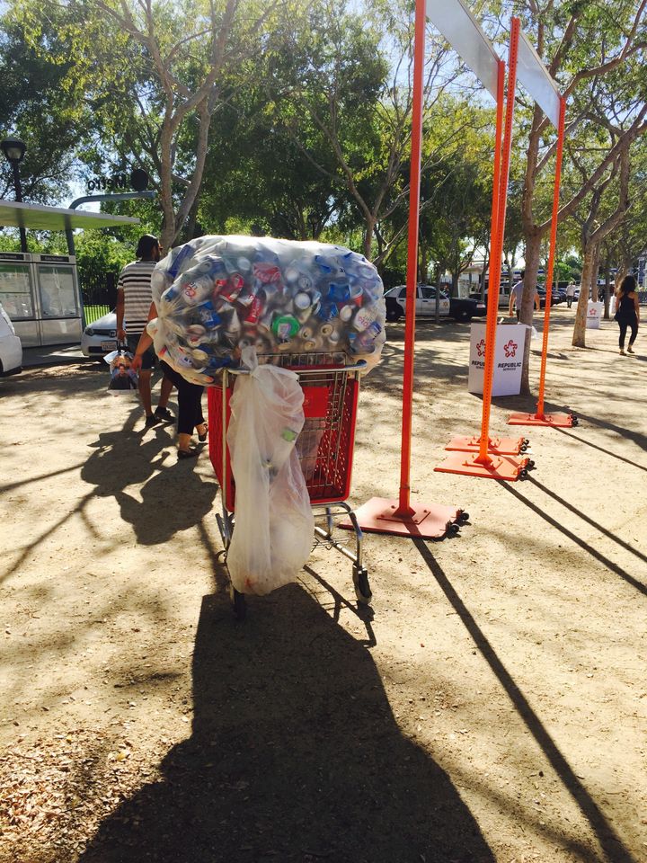 A cart filled with cans pulled from trashcans during a USC football game is one of many surrounding the Coliseum.