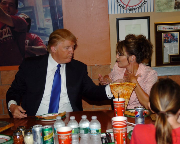 GOP front-runner Donald Trump and former vice presidential candidate Sarah Palin grab a slice of pizza in New York City.