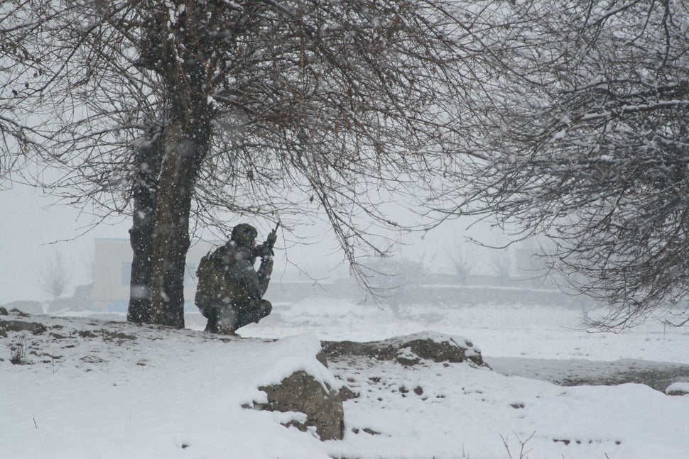 A member of the 2nd Marine Special Operations Battalion readies his weapon near a suspected Taliban location in Afghanistan.