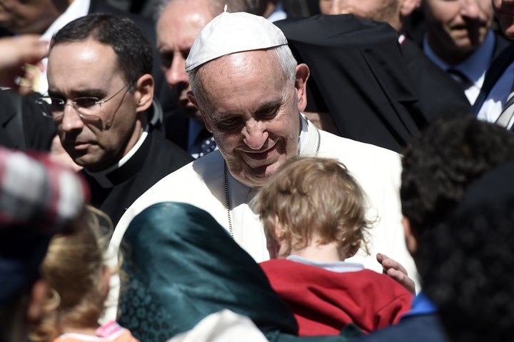 Pope Francis looks at a child at the Moria detention center in Mytilene on April 16, 2016.