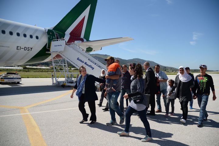 A group of Syrian refugees arrive to board a plane with Pope Francis.