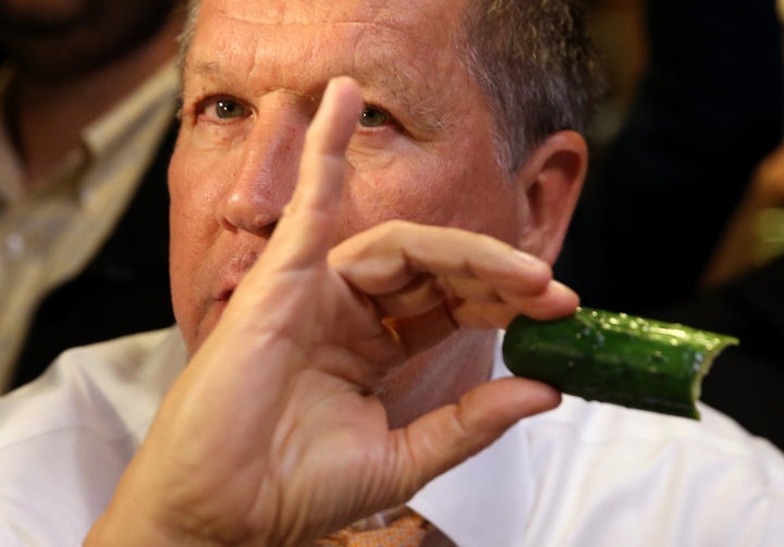 The color of the pickle in Kasich's hand indicates it is not a "full sour" pickle.