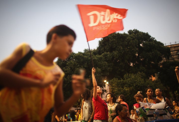 A supporter of President Dilma Rousseff waves a Dilma flag at a 'Carnival for Democracy' on April 16, 2016 in Rio de Janeiro,