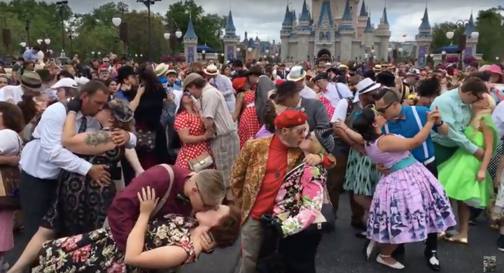 Couples pose in front of the Magic Kingdom's castle during Dapper Day on Saturday.