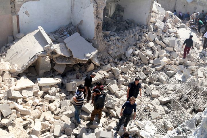 Residents look for survivors amidst the rubble after an airstrike on the rebel-held Old Aleppo, Syria last weekend.
