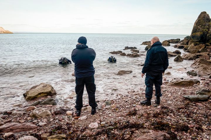 Police divers at Anstey's Cove, where Polge's car was found