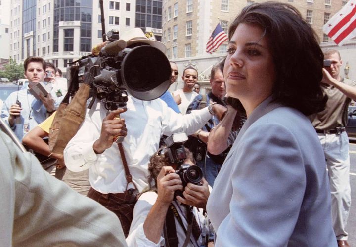 Lewinsky in 1998 is overwhelmed by photographers and reporters as she walks into her lawyer's office. 