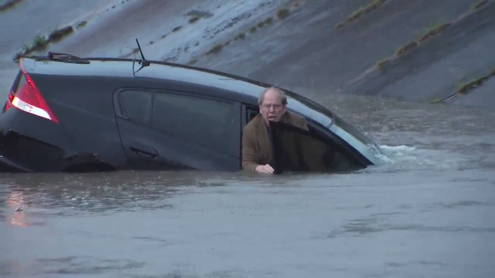 A Houston driver appeared hesitant about abandoning his vehicle as it sank in flood waters Monday morning.