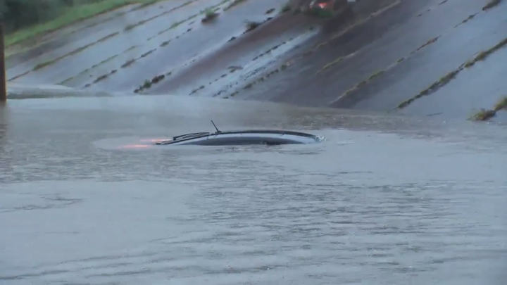 The man's vehicle is seen almost completely submerged just seconds after he climbed out to safety.