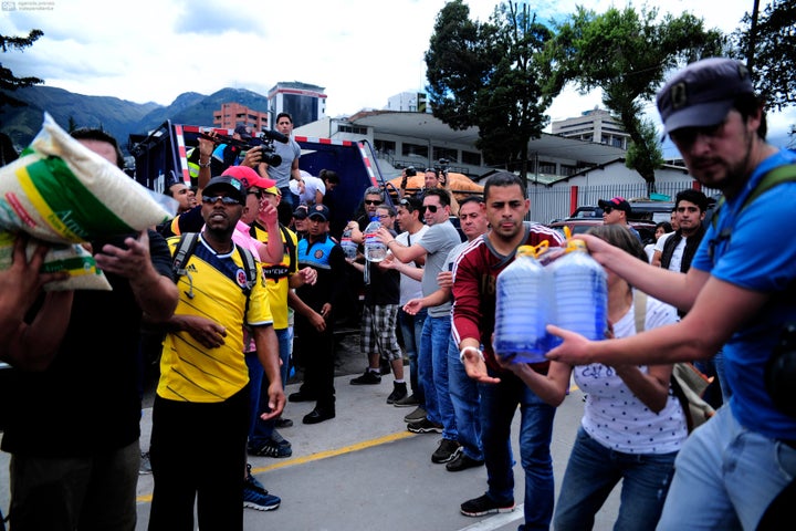 People collect food and water for the victims in Quito after a 7.8 degree earthquake hit Ecuador.