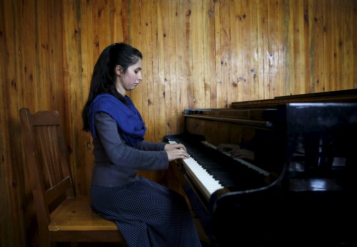 Negin Ekhpulwak, leader of the Zohra orchestra, an ensemble of 35 women, practises on a piano at Afghanistan's National Institute of Music, in Kabul, Afghanistan April 9, 2016.