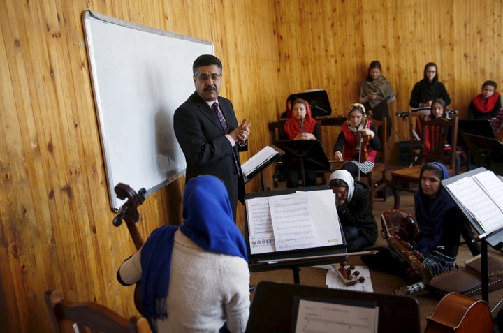 Ahmad Naser Sarmast, head of Afghanistan's National Institute of Music, speaks to members of the orchestra. Playing instruments was banned under Taliban rule in Afghanistan, and many conservative Muslims still frown on most forms of music.