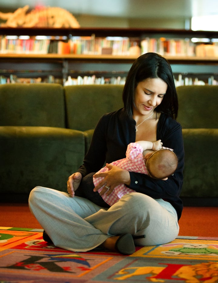 A first grade teacher nursing at the library.