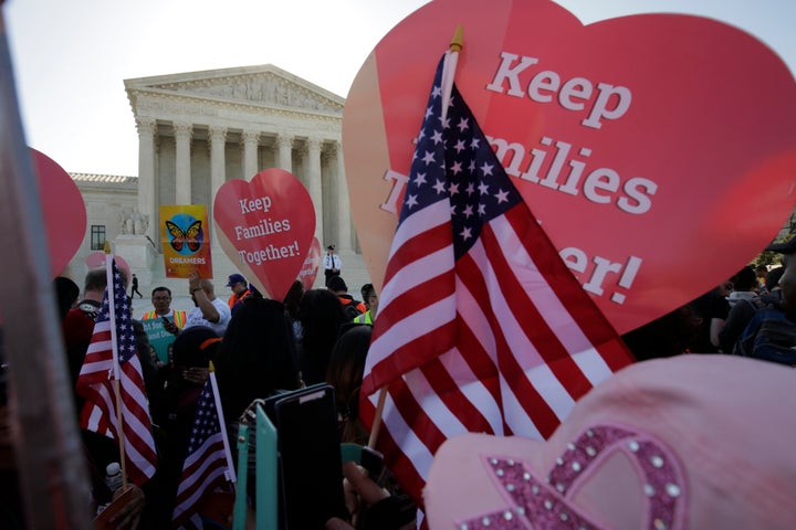 Immigration activists rally outside the Supreme Court as it hears arguments in a multistate challenge to President Barack Obama's executive action to defer deportation of millions.