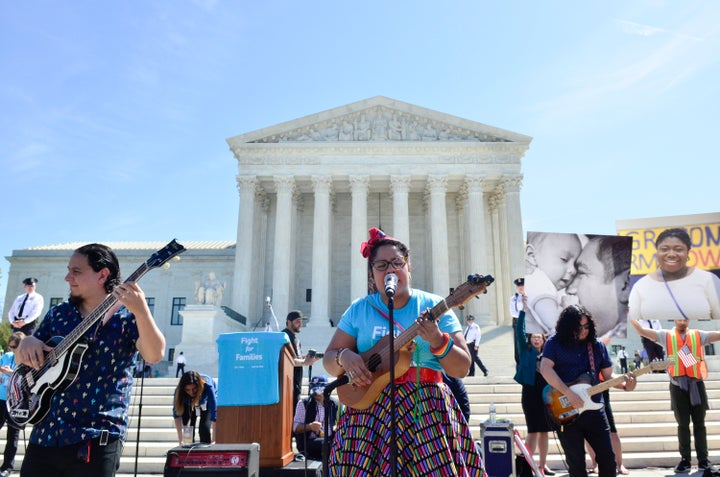 Alex Bendana, La Marisoul and Miguel Ramirez of "La Santa Cecilia" perform during the Fight For Families Rally in front of the Supreme Court Monday.