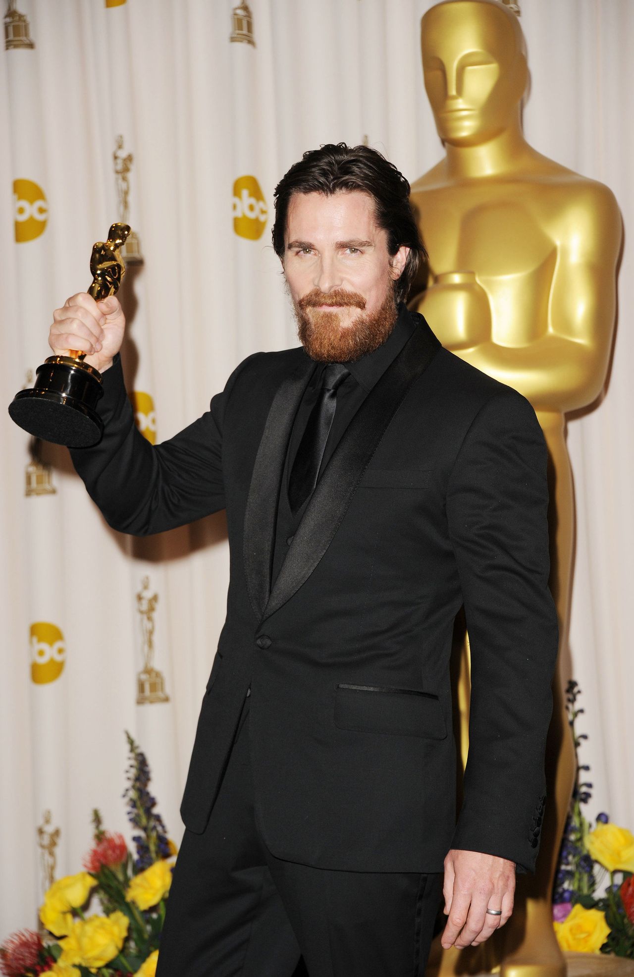 Christian Bale holds his Oscar statue after winning for his role in The Fighter.
