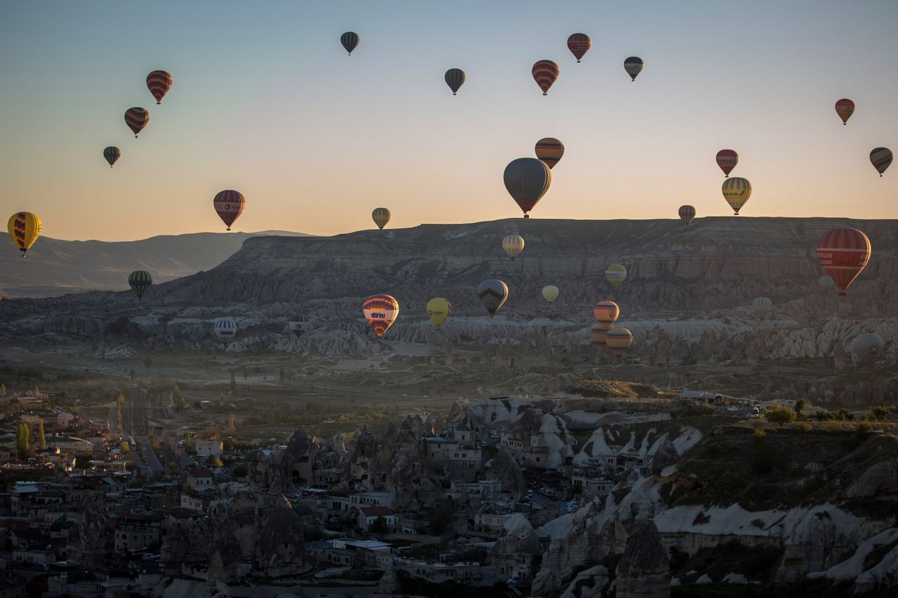 Tourists ride hot air balloon near the town of Goreme on April 17, 2016 in Nevsehir, Turkey.