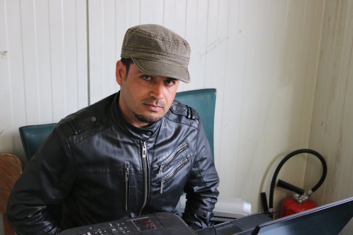 <strong>Besh at the head of the long table in the refugee council's office</strong>