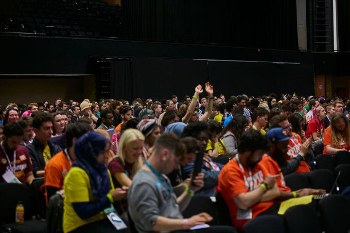 An NUS delegate signals his support for proceedings during the conference on Tuesday