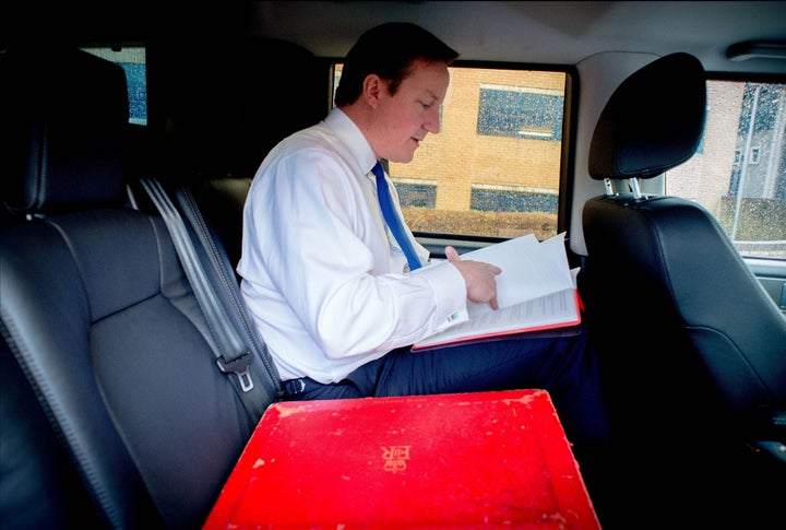 David Cameron pictured in his ministerial car with "red box". Papers were carried around on their own almost 2,000 times over three years.