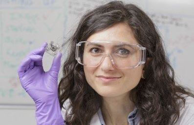 Dr. Mirella Di Lorenzo, a lecturer in the University of Bath's Department of Chemical Engineering, holds a pee-powered fuel cell.