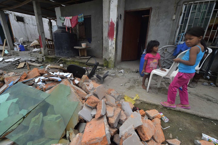 Children are seen at the rubble in one of Ecuador's worst-hit towns, Pedernales, a day after a 7.8-magnitude quake hit the country, on April 17, 2016. 