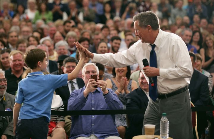 Kasich high-fives a boy who joined him on stage during a town hall meeting in Annapolis, Maryland, this week.