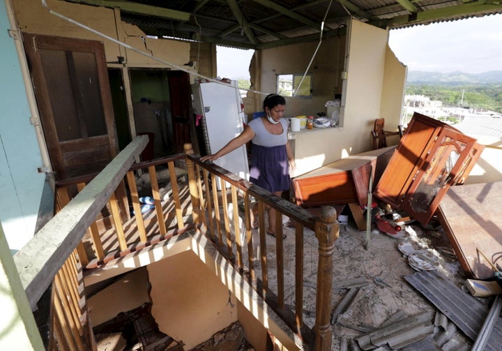 The earthquake that struck Ecuador over the weekend killed 480, left over 100 missing and left 20,000 sleeping in shelters. A woman walks inside her damaged home.