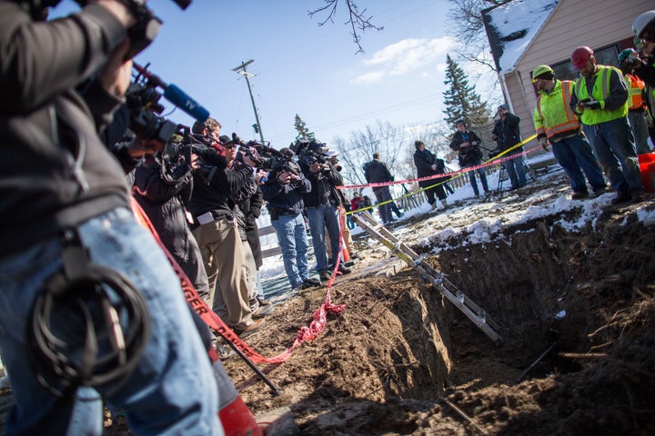 Workers replace an old lead pipe with a new safer copper pipe at a home in Flint, Michigan, March 4, 2016.