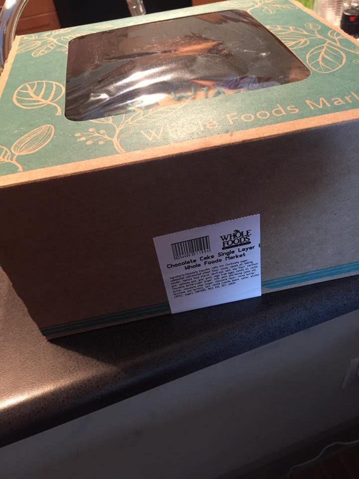 Video and photos of the cake shows the box's white label on its side, not on the top, suggesting that Brown opened the box and then resealed it.