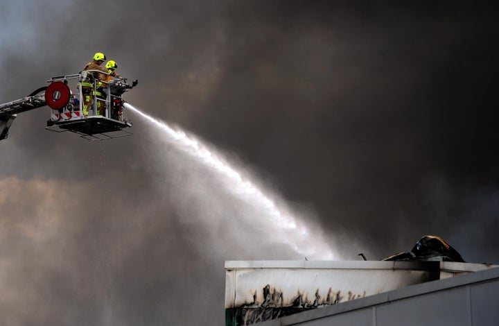 The last of the flames are put out at the Enfield warehouse