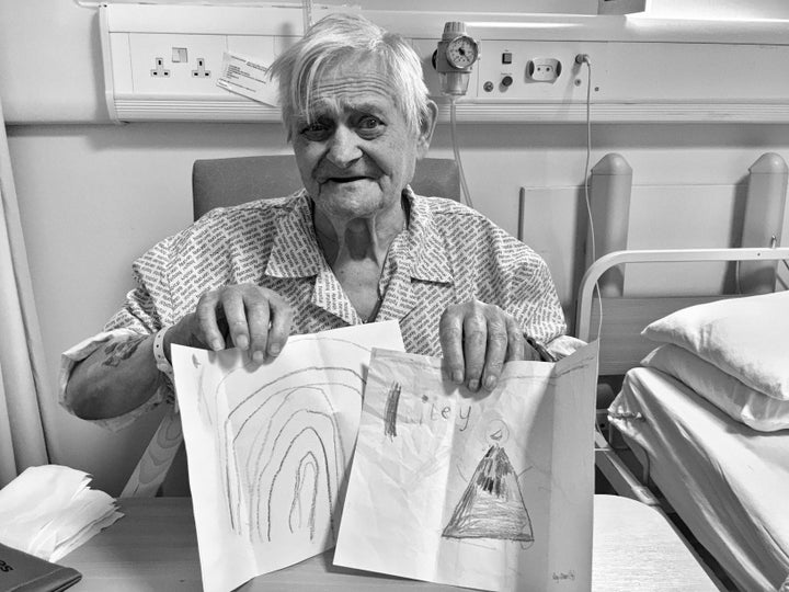 "Groovy Grandpa" posing happily with some of the drawings he received in the mail from friends and family. 