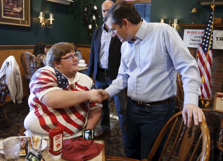 Republican presidential candidate Ted Cruz greets a restaurant patron during a campaign stop on April 3, 2016.