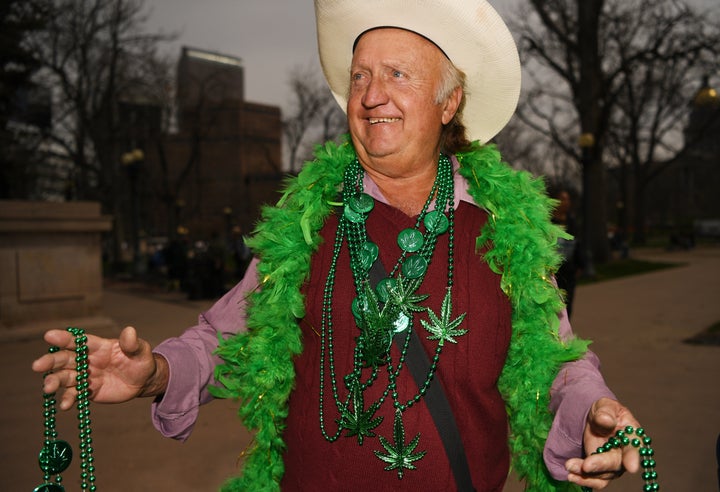 Jerry Ludke sells weed necklaces during the 420 celebration at Civic Center Park in Denver, April 20, 2016. People gather at